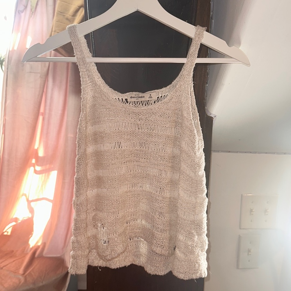 See through white tank top with gold tinsel.
